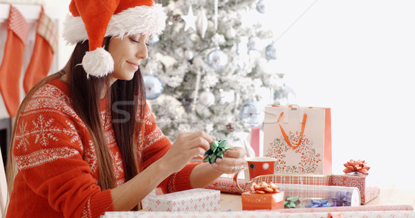 Young woman sitting wrapping Christmas gifts Stock photo © dash