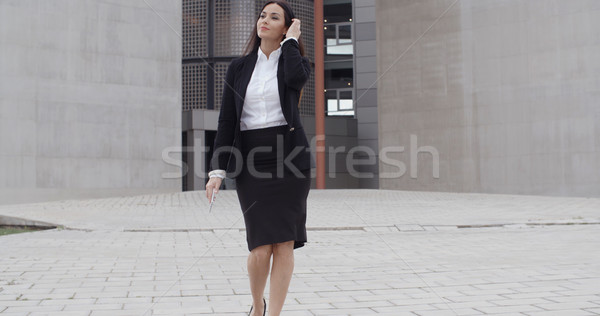 Young businesswoman walking towards the camera Stock photo © dash