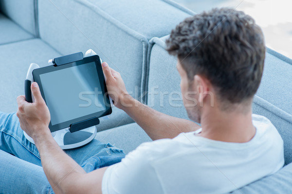 Middle Age Man Using Cool Tablet at Couch Stock photo © dash
