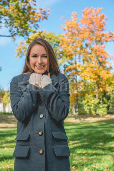 Stock photo: Smiling Pretty Woman Chilling in Gray Coat