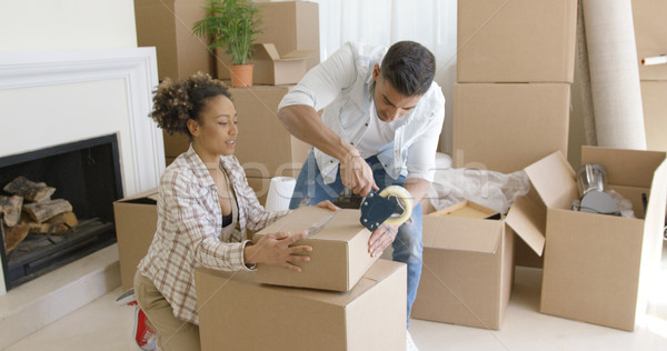 Young couple packing boxes to move home Stock photo © dash