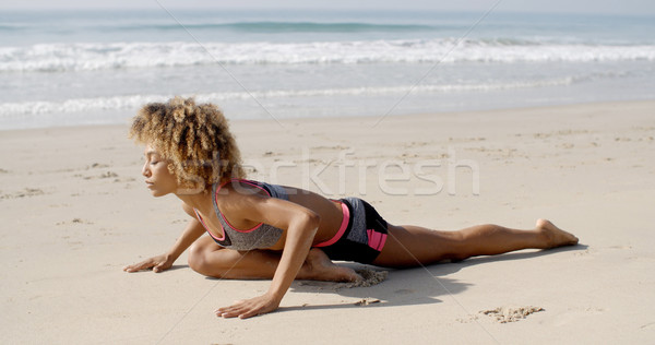 Woman Practicing Yoga At Seashore Stock photo © dash