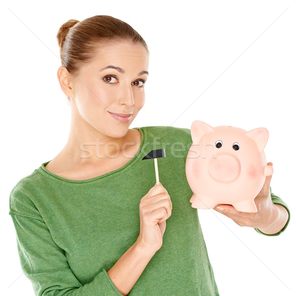Woman testing her piggy bank with a mallet Stock photo © dash