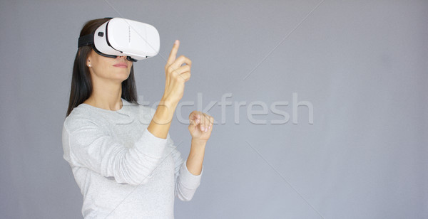 Adorable woman working with virtual reality glasses Stock photo © dash