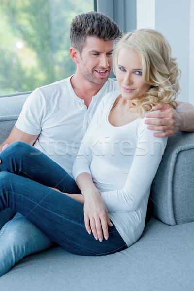 Romantic couple relaxing close together on a sofa Stock photo © dash