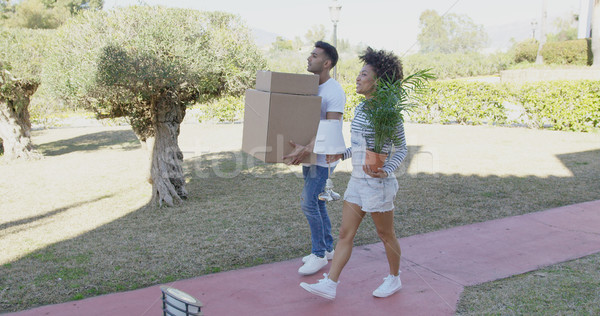 Young couple moving house carrying boxes Stock photo © dash