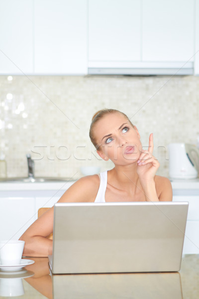 Thinking woman sitting at laptop computer Stock photo © dash