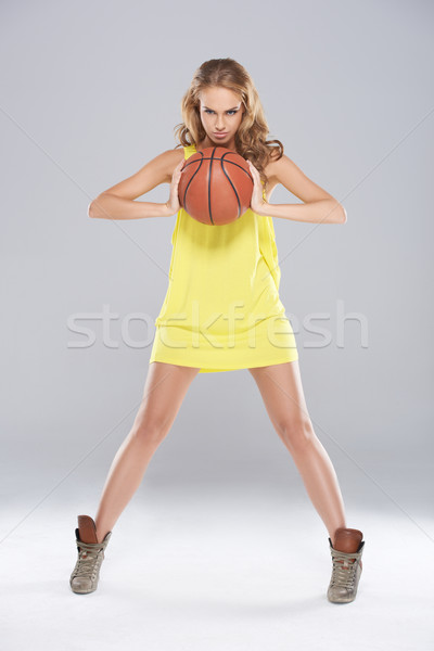 Young blond woman posing and holding basket ball Stock photo © dash