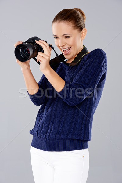 Stock photo: Female photographer assessing her shot