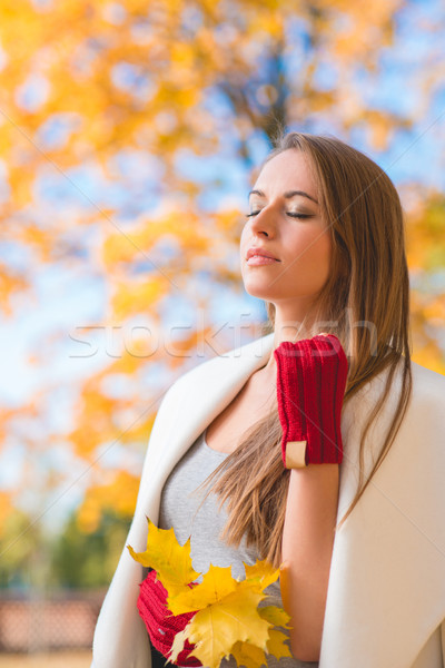 Stock photo: Young woman savoring the beauty of autumn