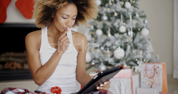 Thoughtful woman catching up on Christmas news Stock photo © dash