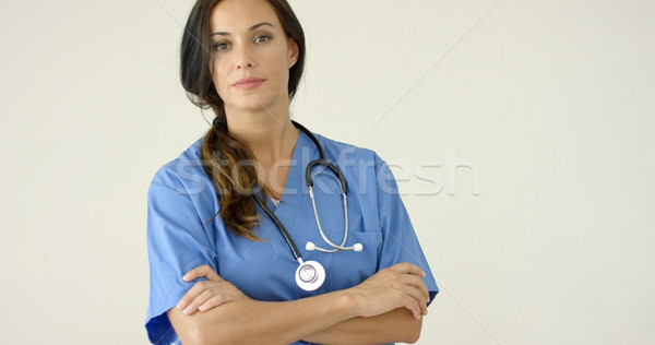 Woman in scrubs crosses arms and smiles at camera Stock photo © dash