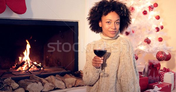 Pretty woman holds wine glass beside fireplace Stock photo © dash
