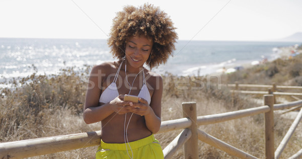 Charming girl using smartphone while training Stock photo © dash