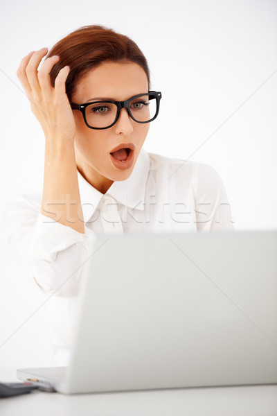 Shocked businesswoman looking at her laptop Stock photo © dash