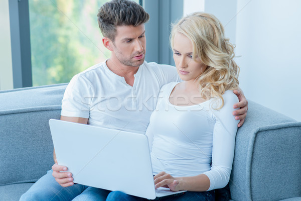 Concerned young couple using a laptop computer Stock photo © dash