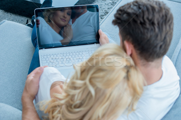 Overhead view of a couple using laptop Stock photo © dash
