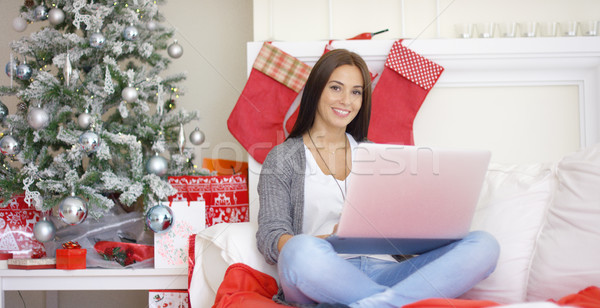 Relaxed young woman working on her laptop Stock photo © dash