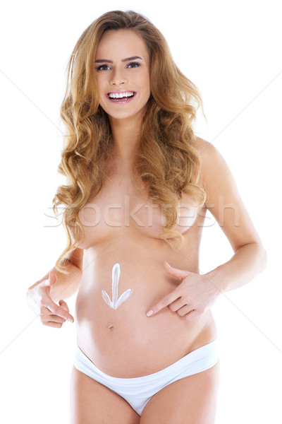 Young pregnant woman with arrow shape pained Stock photo © dash