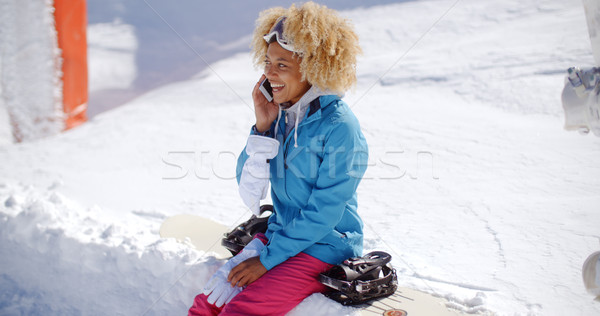 Laughing woman chatting on her mobile in snow Stock photo © dash