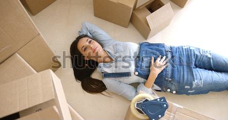 Young woman relaxing on the floor after packing Stock photo © dash