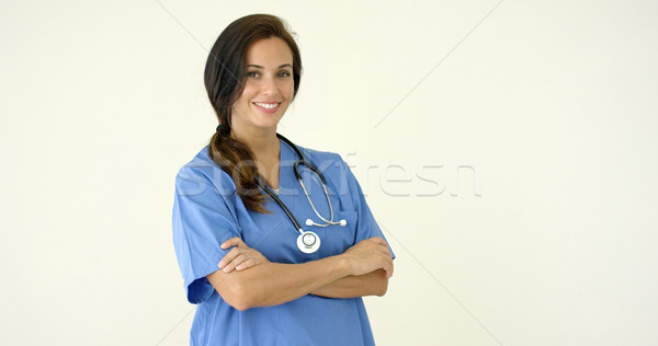 Woman in scrubs crosses arms and smiles at camera Stock photo © dash