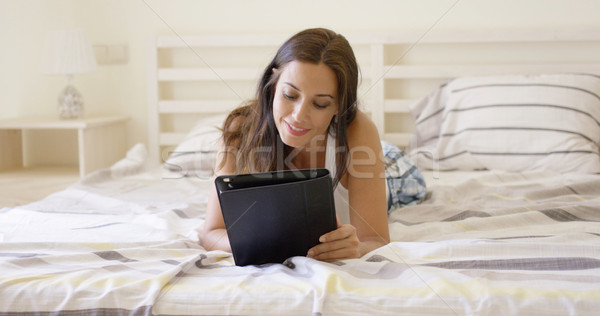 Attractive young woman surfing the internet Stock photo © dash