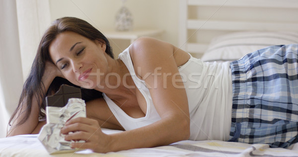 Stock photo: Adorable middle aged woman eating bar of dark chocolate