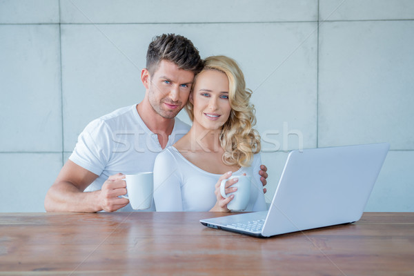 Attractive couple having a mug of coffee Stock photo © dash