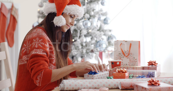 Young woman sitting wrapping Christmas gifts Stock photo © dash