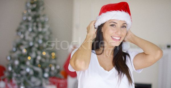 Pretty vivacious woman donning a Santa hat Stock photo © dash