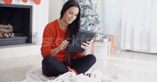 Smiling woman catching up on her social media Stock photo © dash