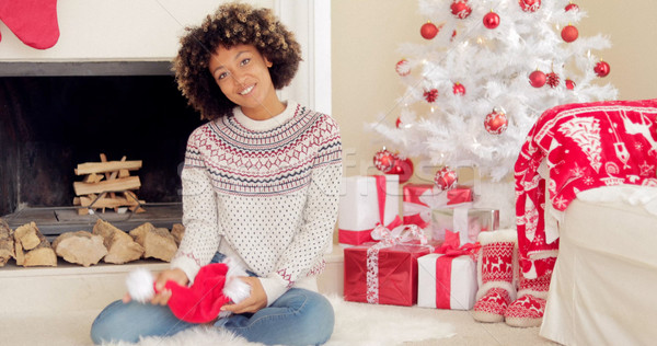 Smiling young woman holding a Santa hat Stock photo © dash