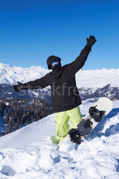 Snowboarder nero giacca posa cielo sport Foto d'archivio © dash