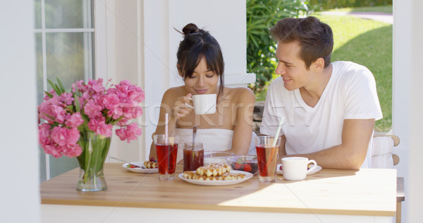 Couple having breakfast at outdoor table Stock photo © dash