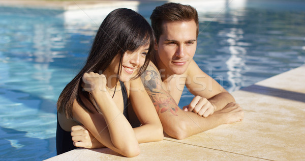 Diverse good looking couple stand in swimming pool Stock photo © dash