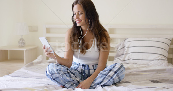 Smiling pretty woman listening to music at home Stock photo © dash