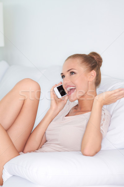 Woman laughing with friends over a mobile Stock photo © dash