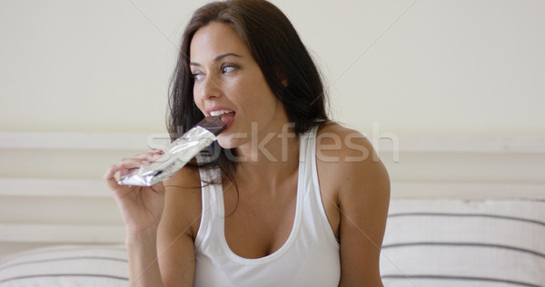 Young woman snacking on a bar of chocolate Stock photo © dash