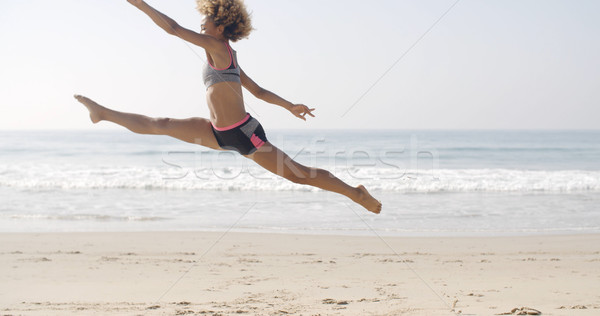 Happy Young Woman Jumping On The Beach Stock photo © dash
