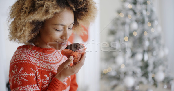 Stock photo: Young woman savoring a Christmas cake