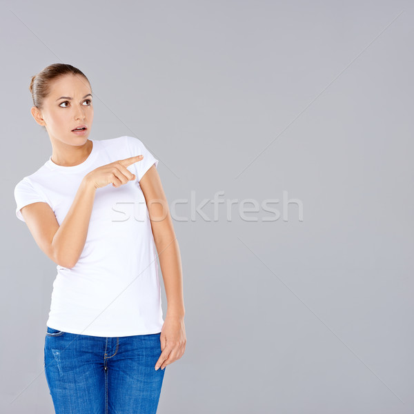 Stock photo: Woman pointing in disbelief