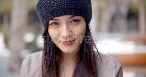 Pretty thoughtful young woman in a woolly cap Stock photo © dash