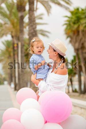 Trendy young mother holding her young daughter Stock photo © dash