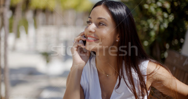 Vivacious young woman chatting on her mobile Stock photo © dash