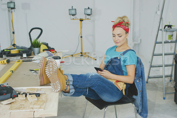 Woman resting with smartphone at carpenter workbench  Stock photo © dash