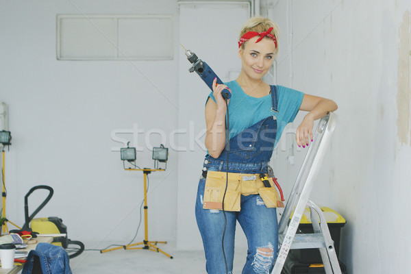 Woman with drill standing on stepladder  Stock photo © dash
