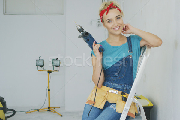Happy woman with drill sitting on stepladder  Stock photo © dash