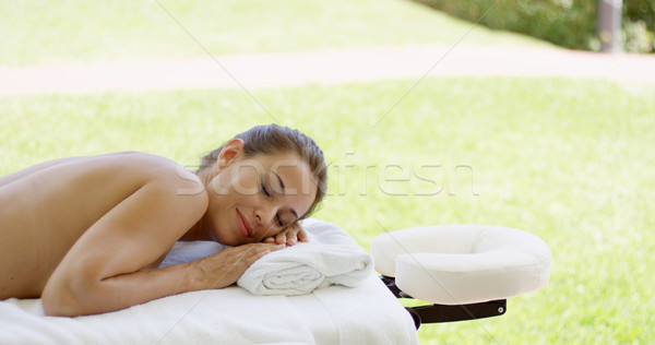Naked woman on spa table closes her eyes Stock photo © dash
