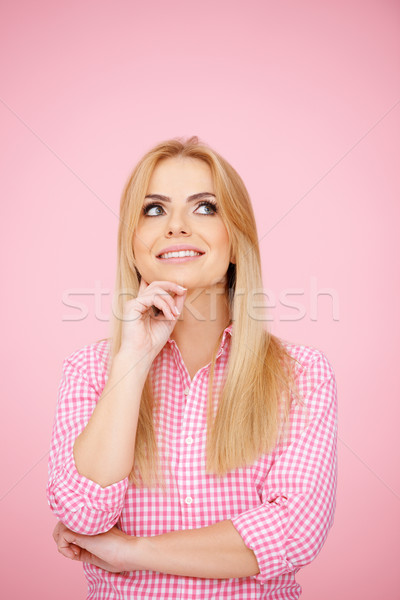 Thoughtful blond girl on pink Stock photo © dash